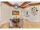 Elegant dining area with round table and statement art at 11227 Macaw Ct, Windermere, FL 34786