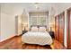 Main bedroom with king-size bed, hardwood floors, and wood doors at 11227 Macaw Ct, Windermere, FL 34786