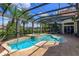 Inviting kidney-shaped pool with spa and screened enclosure at 11227 Macaw Ct, Windermere, FL 34786