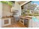 Stainless steel outdoor kitchen with granite countertops at 11227 Macaw Ct, Windermere, FL 34786