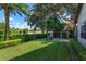 Landscaped backyard with playground set and pond view at 11227 Macaw Ct, Windermere, FL 34786