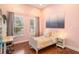 Bright bedroom with a twin bed, built-in shelving, and hardwood floors at 11227 Macaw Ct, Windermere, FL 34786