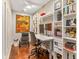 Home office with built-in shelves, a standing desk, and hardwood floors at 11227 Macaw Ct, Windermere, FL 34786