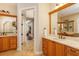 Double vanity bathroom with a view of the hallway and another bathroom at 11227 Macaw Ct, Windermere, FL 34786