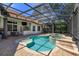 Inviting kidney-shaped pool with spa and screened enclosure at 11227 Macaw Ct, Windermere, FL 34786