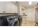 Laundry room with washer, dryer, and built-in cabinets at 11227 Macaw Ct, Windermere, FL 34786
