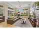 Gathering room with leather sectional sofa and views to pool and golf course at 11227 Macaw Ct, Windermere, FL 34786