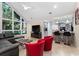 Open living space with sectional sofa, red accent chairs, and a view of the kitchen at 530 Estates Pl, Longwood, FL 32779