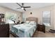 Cozy bedroom with a queen-size bed and large windows at 530 Estates Pl, Longwood, FL 32779