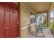 Inviting front porch with red door and rocking chairs at 1139 August Sky Dr, Deltona, FL 32738