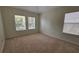 Well-lit bedroom with carpet and two windows at 10759 Gran Paradiso Dr # S, Orlando, FL 32832