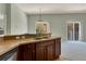 Kitchen island with double sink and wood cabinets at 10759 Gran Paradiso Dr # S, Orlando, FL 32832