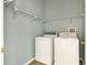 Laundry room with washer, dryer, and shelving at 10759 Gran Paradiso Dr # S, Orlando, FL 32832