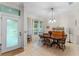 Bright dining room with a wood table and chairs, and a view into the living room at 8038 Glitter Ct, Orlando, FL 32836