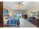 Main bedroom with a king-size bed, dresser, and sliding doors to backyard at 8038 Glitter Ct, Orlando, FL 32836