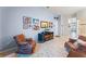 Home office with two armchairs and built-in storage at 8038 Glitter Ct, Orlando, FL 32836