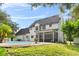 Two-story house with a pool and screened porch at 12200 Treetop Ct, Orlando, FL 32832