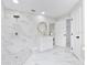Elegant bathroom with marble tile and a large shower at 12200 Treetop Ct, Orlando, FL 32832