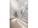 Bright and airy entryway with staircase and view into living area at 12200 Treetop Ct, Orlando, FL 32832