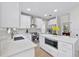 White kitchen with stainless steel appliances and quartz countertops at 12200 Treetop Ct, Orlando, FL 32832