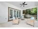 Relaxing screened porch with wicker furniture at 12200 Treetop Ct, Orlando, FL 32832
