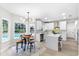 Modern kitchen with white cabinets, large island, and stainless steel appliances at 12200 Treetop Ct, Orlando, FL 32832