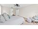 Bright bedroom with a king-size bed, light walls, and a ceiling fan at 12200 Treetop Ct, Orlando, FL 32832