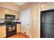 Kitchen features black appliances and light wood cabinets at 322 E Central Blvd # 1214, Orlando, FL 32801