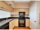 Modern kitchen with black appliances and light wood cabinets at 322 E Central Blvd # 1214, Orlando, FL 32801