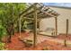 Brick patio with wooden pergola and bench, perfect for relaxing at 185 Post Way, Casselberry, FL 32707