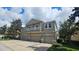 Tan three-story townhome with double garage and balconies at 10759 Gran Paradiso Dr # S, Orlando, FL 32832