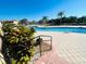 Community pool with patio and lush tropical landscaping at 1431 Pacific Rd, Poinciana, FL 34759