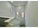 Open staircase with multiple windows offering abundant natural light at 1431 Pacific Rd, Poinciana, FL 34759