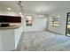 Spacious dining area with carpeted floors and access to the kitchen at 1431 Pacific Rd, Poinciana, FL 34759