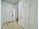 Clean entryway with tile floor, stairs, and coat closet at 1431 Pacific Rd, Poinciana, FL 34759