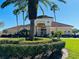 Community clubhouse with palm trees and manicured landscaping at 1431 Pacific Rd, Poinciana, FL 34759