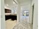 View from hallway showcasing a kitchen with dark brown cabinets at 1431 Pacific Rd, Poinciana, FL 34759