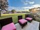 Relaxing patio with wicker furniture, overlooking a grassy area at 1431 Pacific Rd, Poinciana, FL 34759