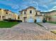 Two-story home with a two-car garage and well-maintained landscaping at 1431 Pacific Rd, Poinciana, FL 34759