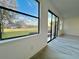 Living room showcasing a view of the backyard and sliding glass doors at 1431 Pacific Rd, Poinciana, FL 34759