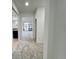 Bright hallway with carpeted floors leading to the living room and kitchen at 1431 Pacific Rd, Poinciana, FL 34759