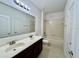 Bathroom with double vanity, tub, and updated fixtures at 1431 Pacific Rd, Poinciana, FL 34759