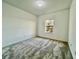 Spacious bedroom with neutral carpeting and large window at 1431 Pacific Rd, Poinciana, FL 34759