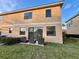 Rear exterior view, showing patio and sliding glass doors at 1431 Pacific Rd, Poinciana, FL 34759