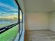 Bedroom with large window overlooking green space at 1431 Pacific Rd, Poinciana, FL 34759