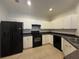 Kitchen with black appliances and white cabinets at 11434 Jasper Kay Ter # 306, Windermere, FL 34786