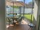 Relaxing poolside patio with table and chairs, offering a shaded seating area at 8038 Glitter Ct, Orlando, FL 32836