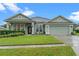 House exterior with landscaping and driveway at 8038 Glitter Ct, Orlando, FL 32836