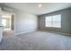 Well-lit bedroom featuring grey walls and carpet at 5480 Palomino Pl, Apopka, FL 32712