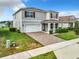 Two story house with red shutters, white garage door and landscaping at 5480 Palomino Pl, Apopka, FL 32712